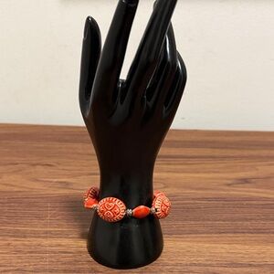 Carved Red Orange Beaded Vintage Bracelet with Silver Tone Decorative Spacers.